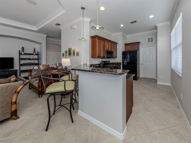 kitchen with pendant lighting, kitchen peninsula, black appliances, dark stone counters, and crown molding