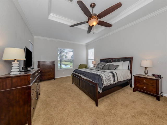 carpeted bedroom with ornamental molding, a tray ceiling, and ceiling fan