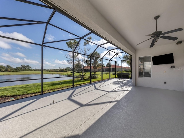 unfurnished sunroom with a water view and ceiling fan