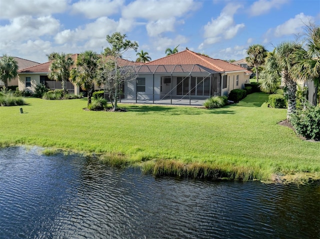 rear view of property featuring a water view, glass enclosure, a patio, and a yard