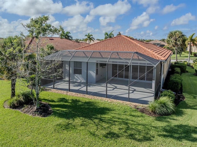 126 Cipriani Way N, Venice, FL 34275 - rear view of house featuring a lawn, a tile roof, a patio area, and glass enclosure