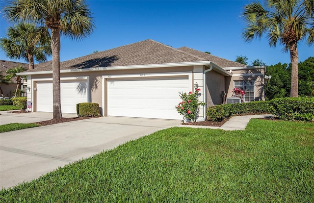 ranch-style home featuring central AC unit, a garage, and a front lawn