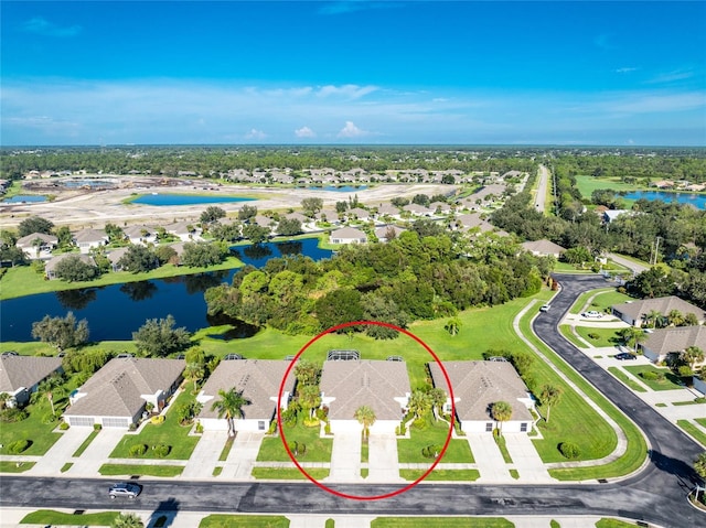 birds eye view of property with a residential view and a water view