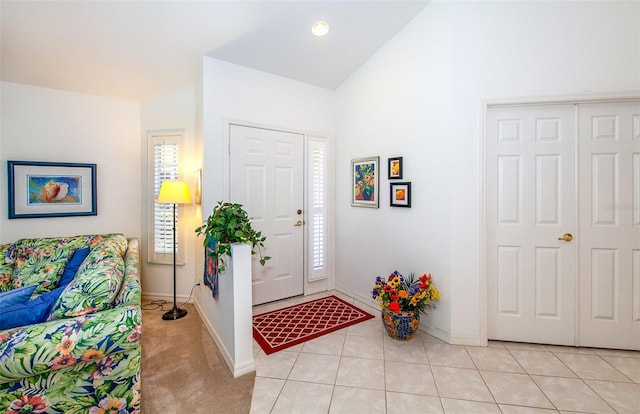 tiled foyer entrance with lofted ceiling