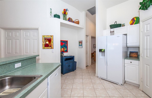 kitchen with light tile patterned flooring, high vaulted ceiling, white appliances, and white cabinets