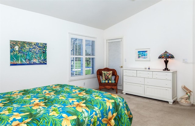 bedroom with lofted ceiling and light carpet