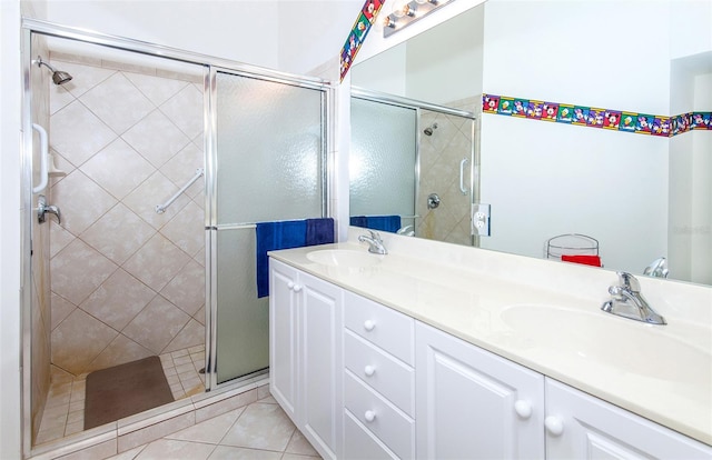 bathroom featuring vanity, an enclosed shower, and tile patterned floors