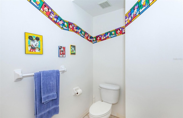 bathroom with toilet, baseboards, and visible vents
