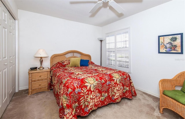 bedroom featuring a closet, carpet flooring, baseboards, and a ceiling fan
