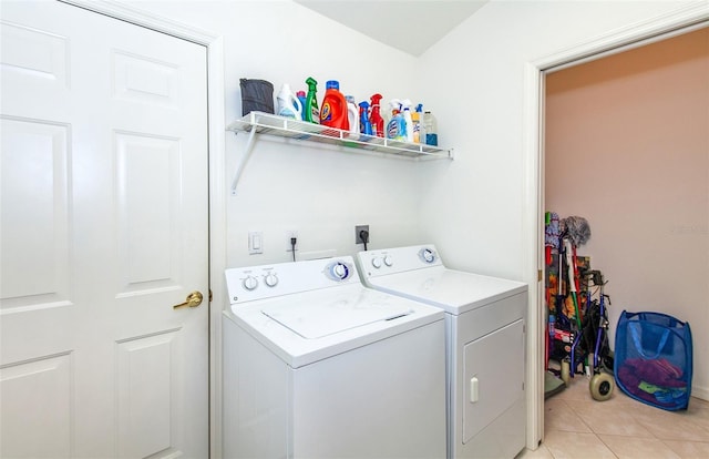 washroom featuring laundry area, light tile patterned flooring, and washer and clothes dryer