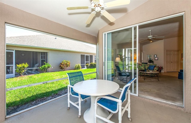 sunroom with outdoor dining area and ceiling fan