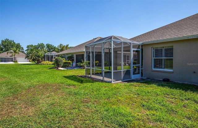 view of yard with glass enclosure