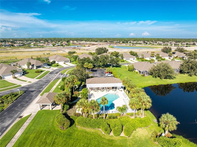 drone / aerial view featuring a water view and a residential view