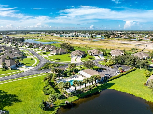 drone / aerial view featuring a water view and a residential view