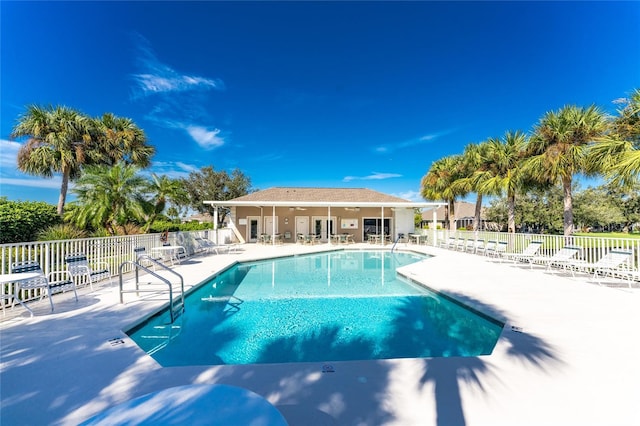 pool featuring fence and a patio