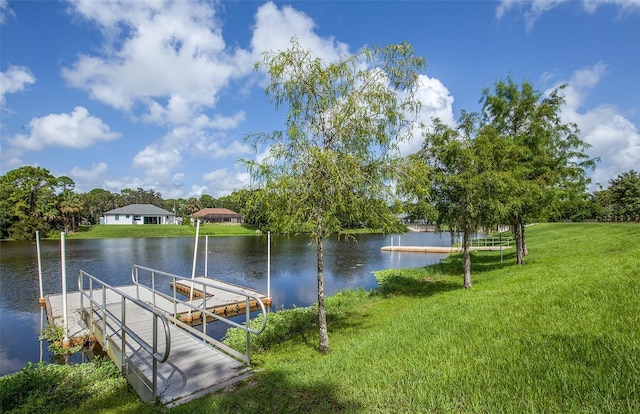 dock area featuring a yard and a water view