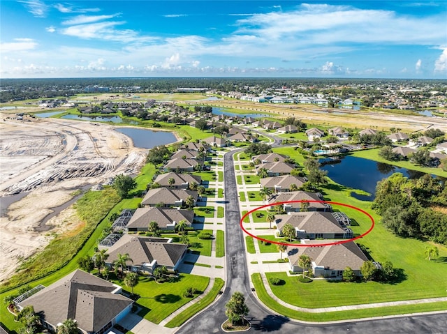 drone / aerial view featuring a water view and a residential view