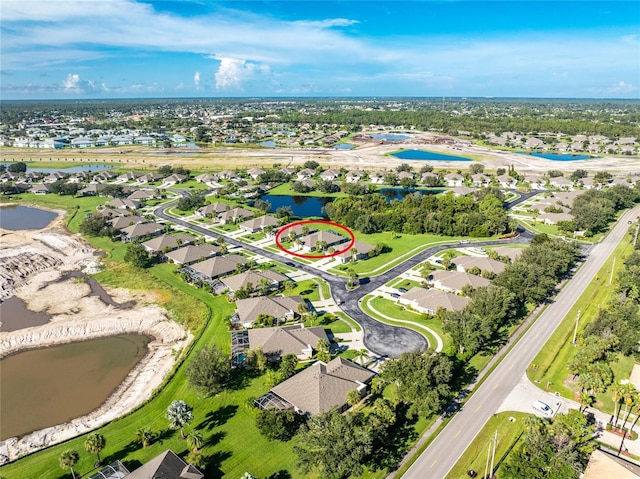 bird's eye view featuring a residential view and a water view