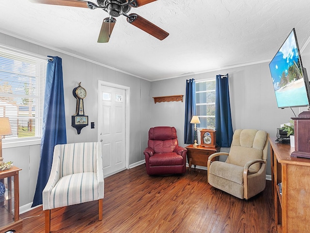 living area with hardwood / wood-style floors, crown molding, a textured ceiling, and ceiling fan