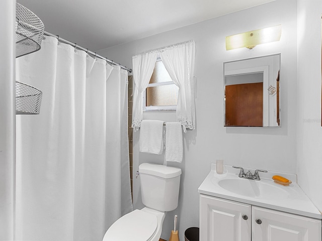 bathroom featuring vanity, a shower with curtain, and toilet