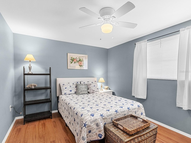 bedroom with hardwood / wood-style floors and ceiling fan