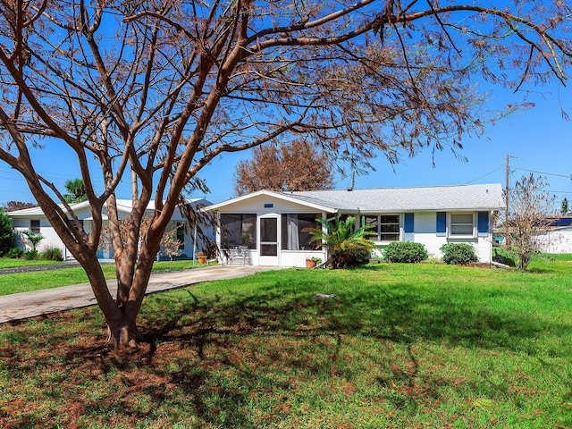 single story home with a front lawn and a sunroom