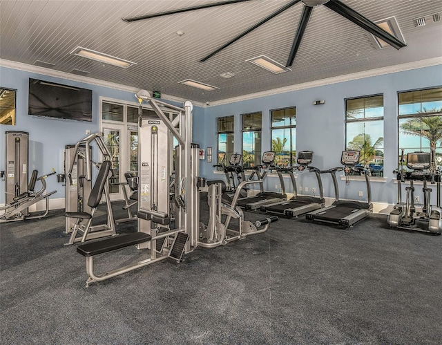 exercise room featuring crown molding and water heater