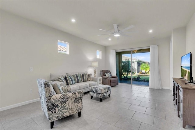 living room featuring light tile patterned floors, plenty of natural light, and ceiling fan