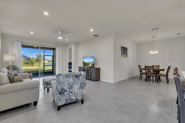 living room featuring ceiling fan with notable chandelier