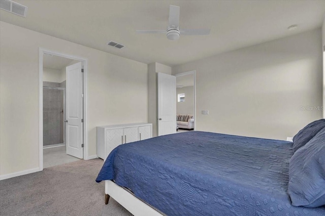 bedroom with light colored carpet, ensuite bath, and ceiling fan