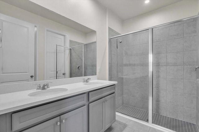 bathroom with tile patterned floors, vanity, and an enclosed shower