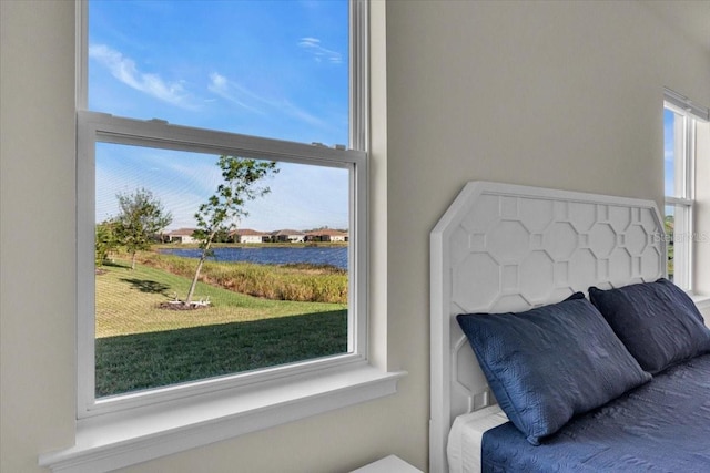 bedroom featuring a water view