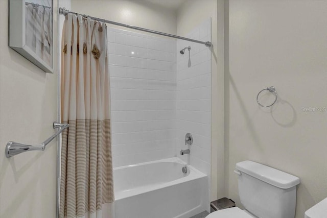 bathroom with toilet and shower / tub combo with curtain