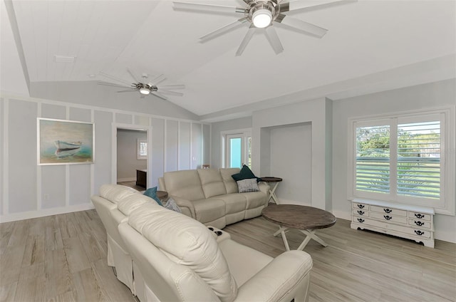 living room featuring ceiling fan, light hardwood / wood-style flooring, and lofted ceiling