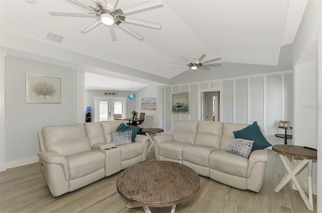 living room with french doors, light hardwood / wood-style flooring, ceiling fan, and lofted ceiling