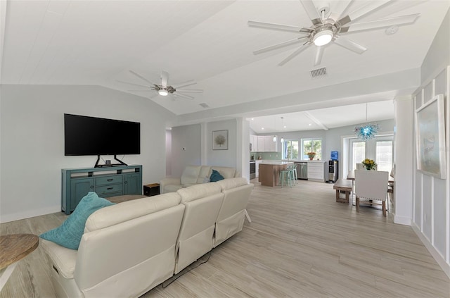 living room featuring ceiling fan with notable chandelier, lofted ceiling, and light hardwood / wood-style flooring