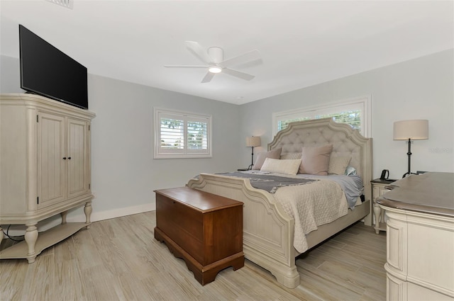 bedroom with light hardwood / wood-style flooring and ceiling fan