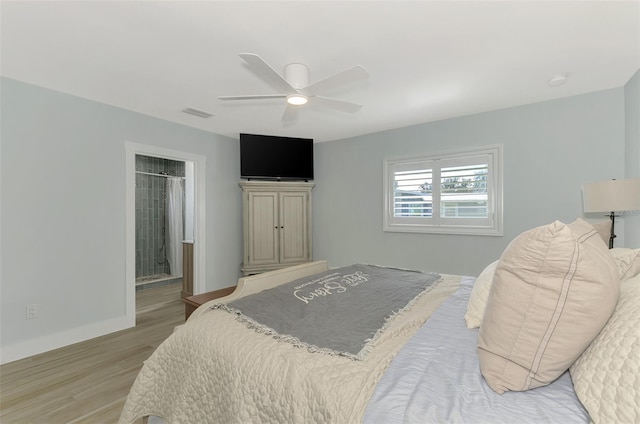 bedroom with ceiling fan, light hardwood / wood-style flooring, and ensuite bath