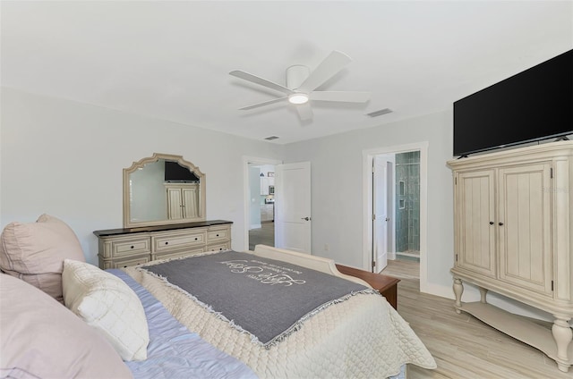 bedroom with ensuite bath, ceiling fan, and light hardwood / wood-style flooring