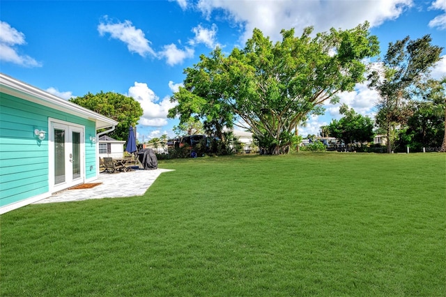 view of yard featuring a patio area and french doors