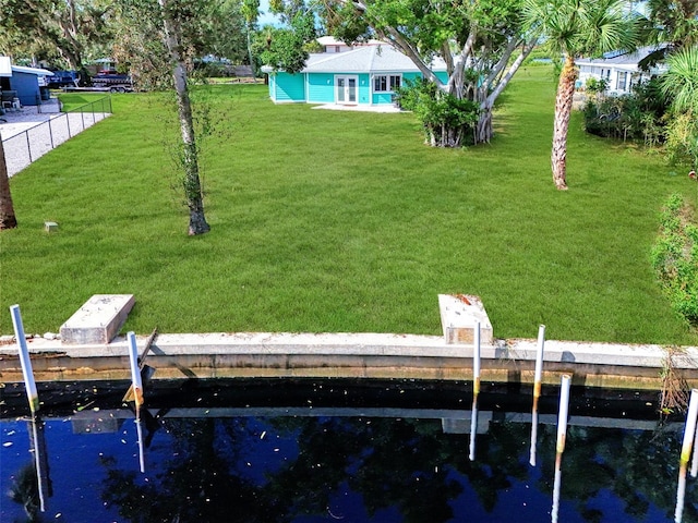 view of yard featuring a boat dock and a water view