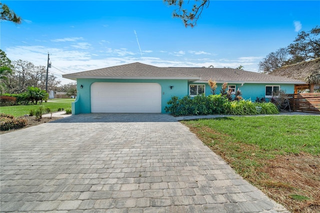 ranch-style house with a front lawn and a garage