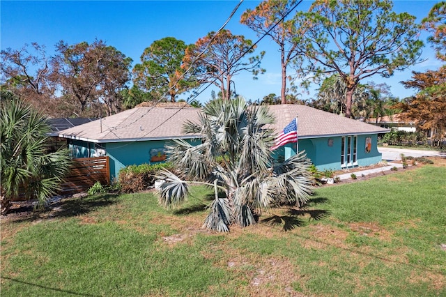 back of house with a lawn