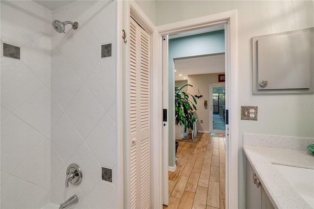 bathroom featuring vanity and a tile shower