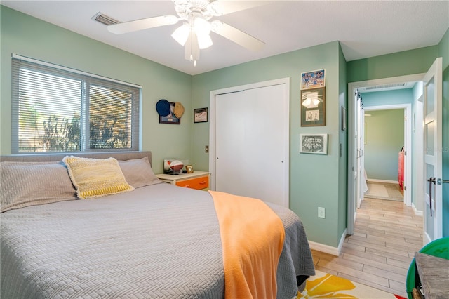 bedroom featuring a closet, ceiling fan, and light wood-type flooring