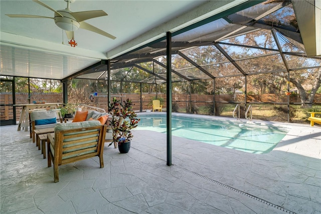 view of pool featuring ceiling fan, a patio, and a lanai