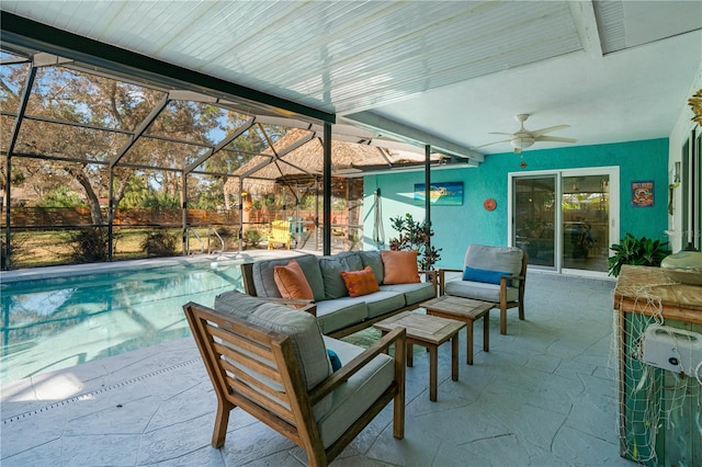 view of patio featuring a lanai, outdoor lounge area, and ceiling fan