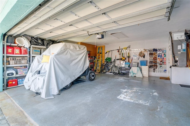 garage featuring a garage door opener and heating unit