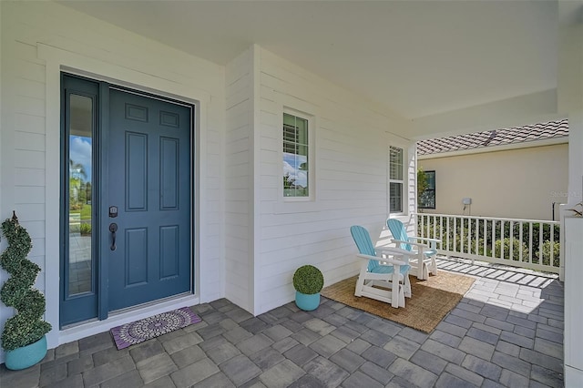 property entrance with covered porch