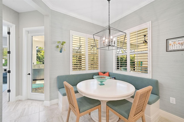 dining area featuring breakfast area, an inviting chandelier, crown molding, and plenty of natural light